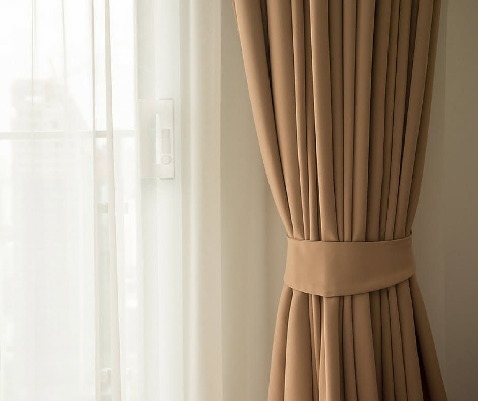 Sliding Glass Doors With Black Frames and Sheer White Curtains on a Patio — Instyle Curtains & Blinds in Bungalow, QLD