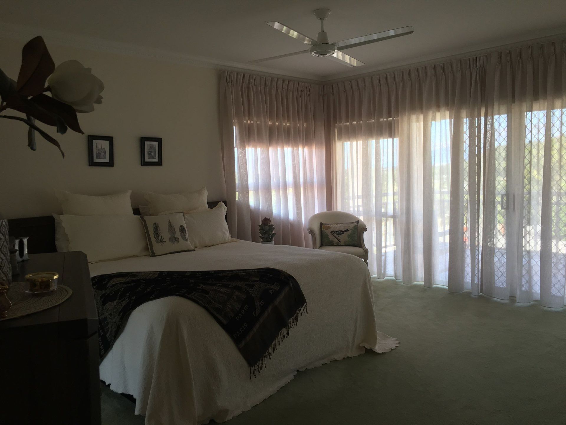 Bedroom With a Bed, Chair, Sheer Curtains, and a View of the Outdoors — Instyle Curtains & Blinds in Bungalow, QLD