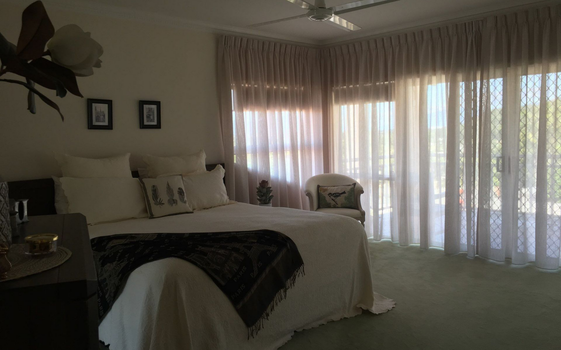 Bedroom With Bed, Sheer Curtains, and a View of the Outdoors — Instyle Curtains & Blinds in Bungalow, QLD
