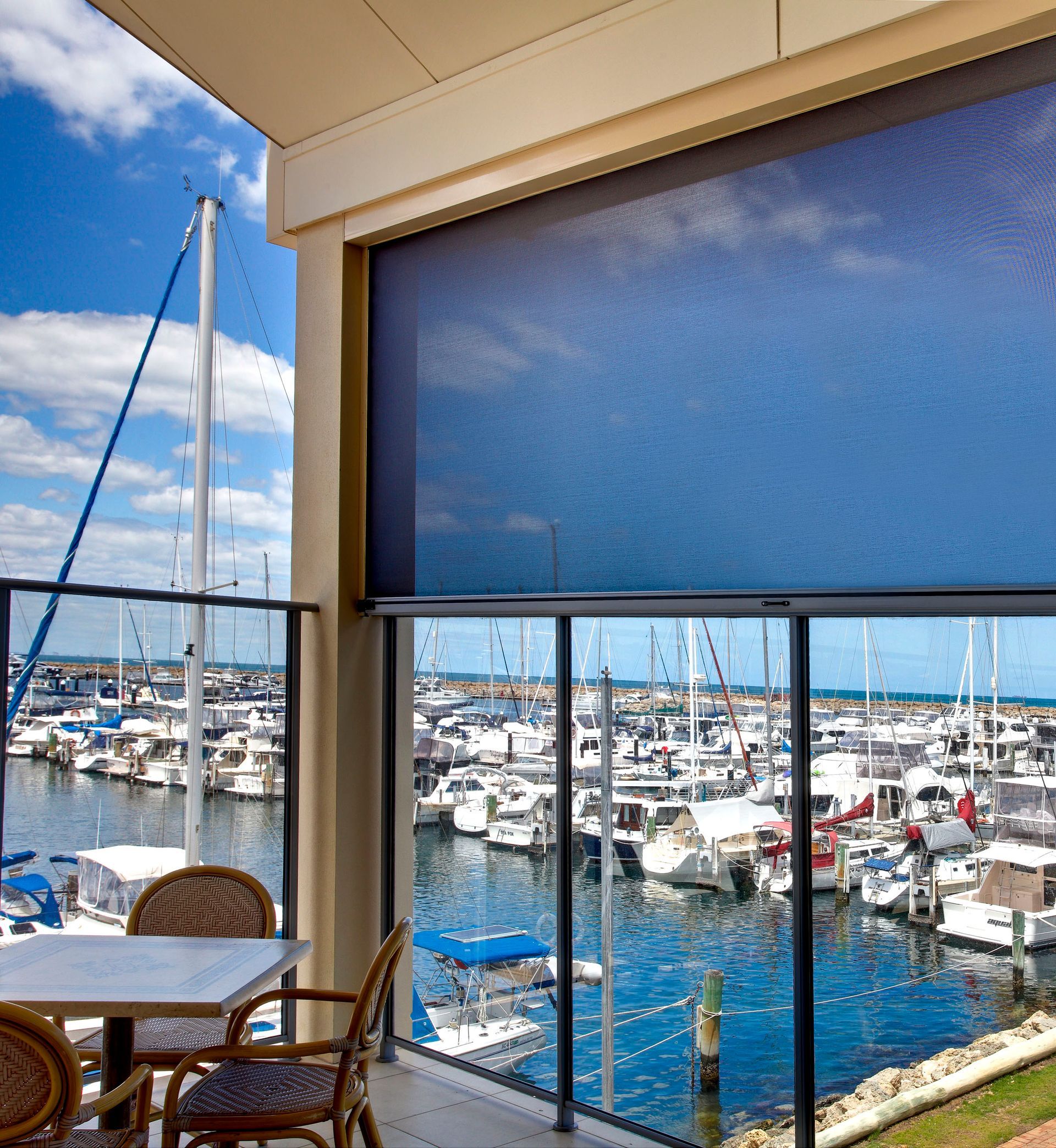 Bedroom With Bed, Bench, Rug, Plant, Window Shade, and Hanging Light Fixture — Instyle Curtains & Blinds in Bungalow, QLD