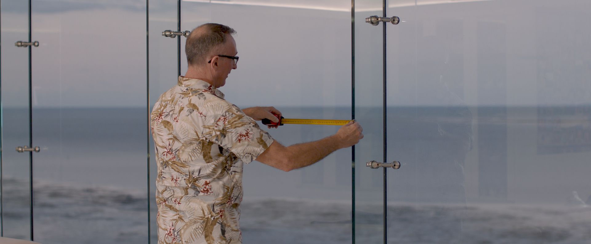 Person on a Ladder Installing Blinds on a Window Frame — Instyle Curtains & Blinds in Bungalow, QLD
