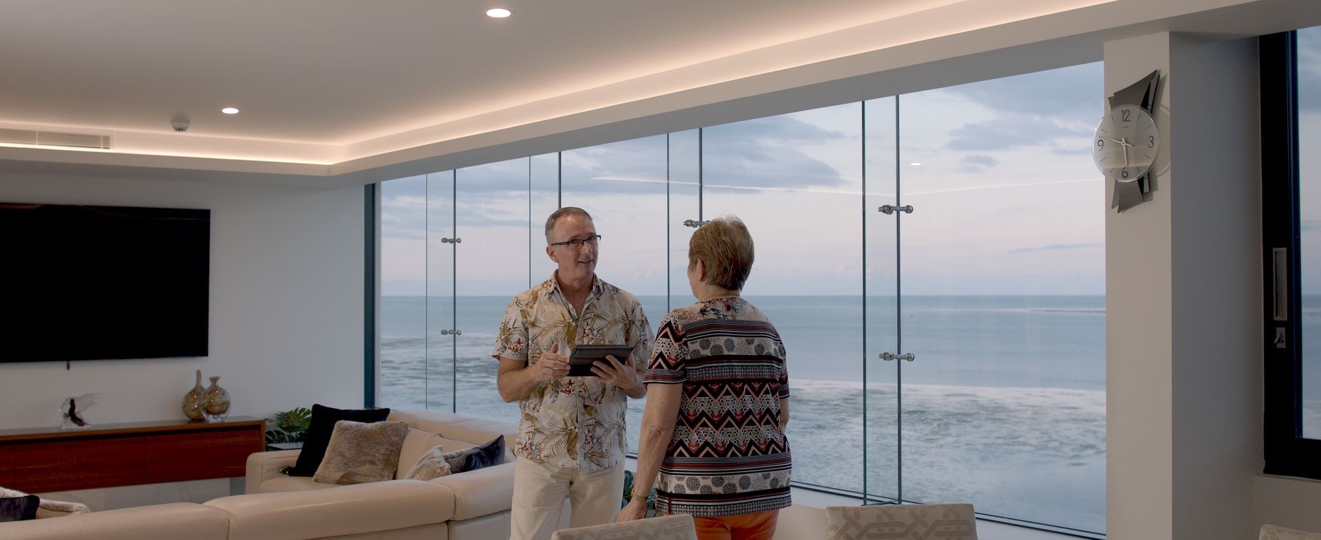 Blue Curtains and White Chair in Front of a Window — Instyle Curtains & Blinds in Bungalow, QLD
