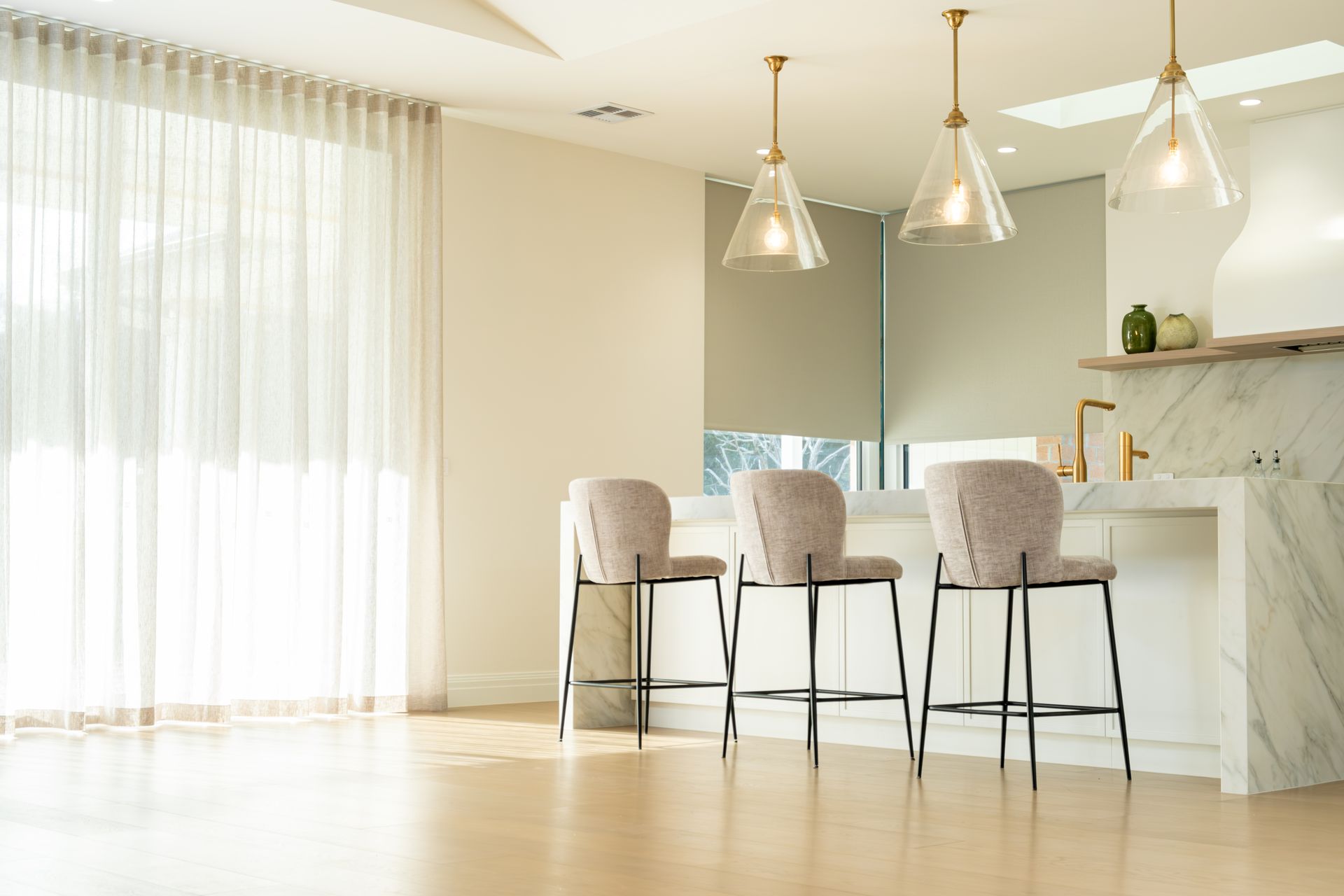 Gray Living Room With a Tufted Couch, Sheer Curtains, and a Glass Coffee Table — Instyle Curtains & Blinds in Bungalow, QLD