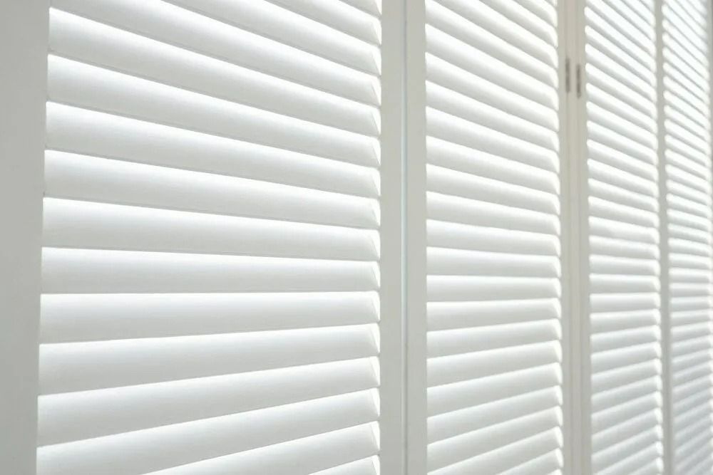 White Wooden Shutters With Horizontal Slats, Partially Open, Letting in Light — Instyle Curtains & Blinds in Bungalow, QLD