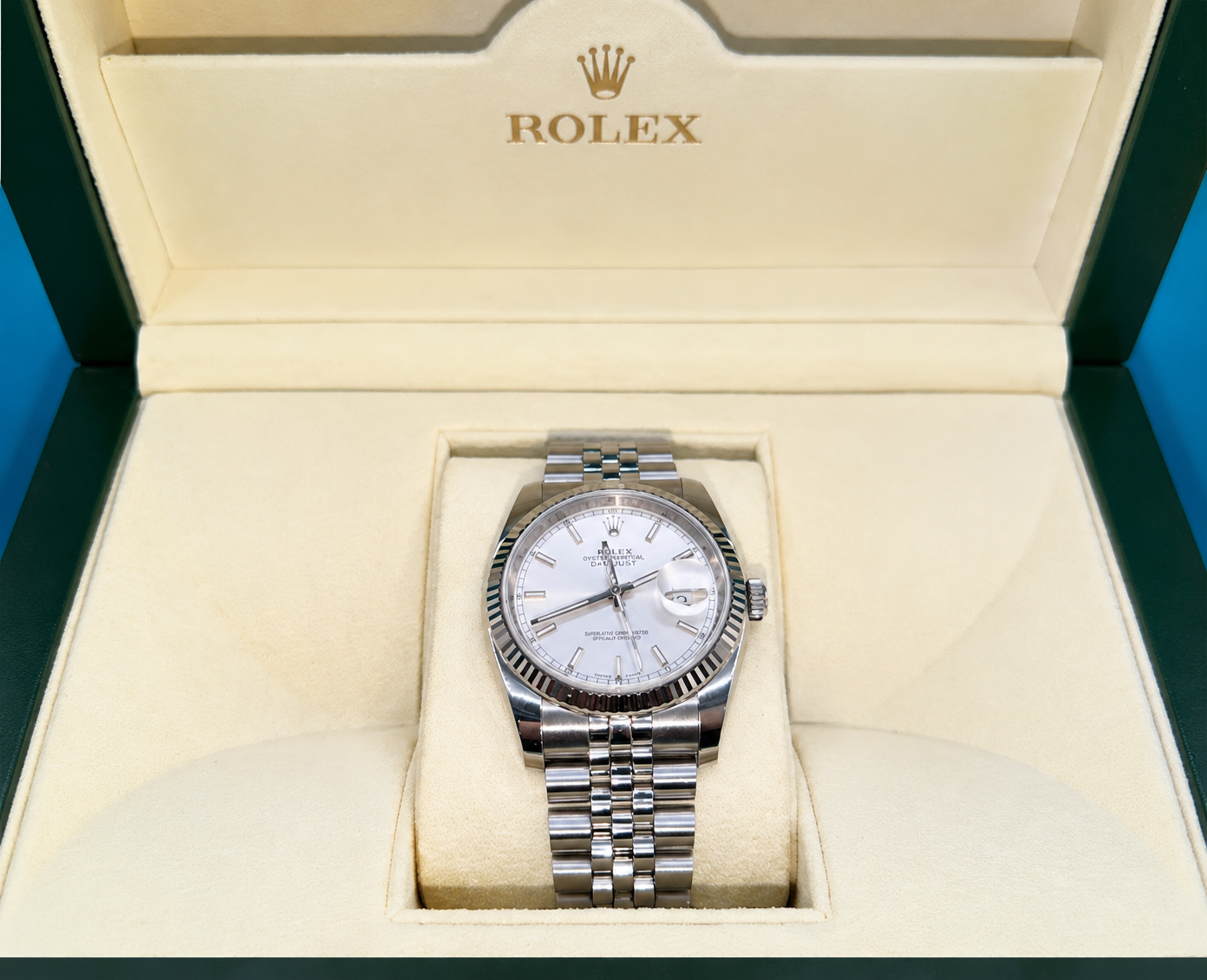 Rolex wristwatch with silver dial in an open cream presentation box