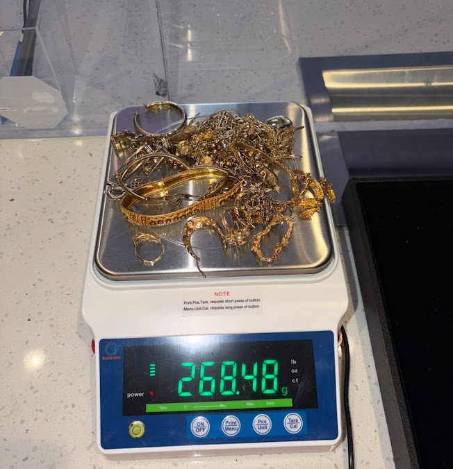Jewelry on a digital scale, showing 268.48 grams