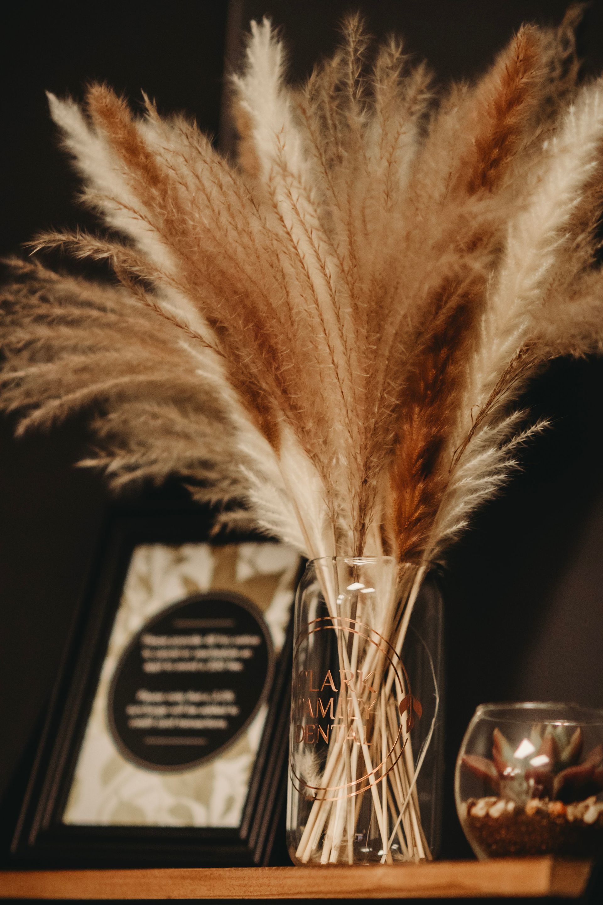 A living room with two couches and three mirrors on the wall.