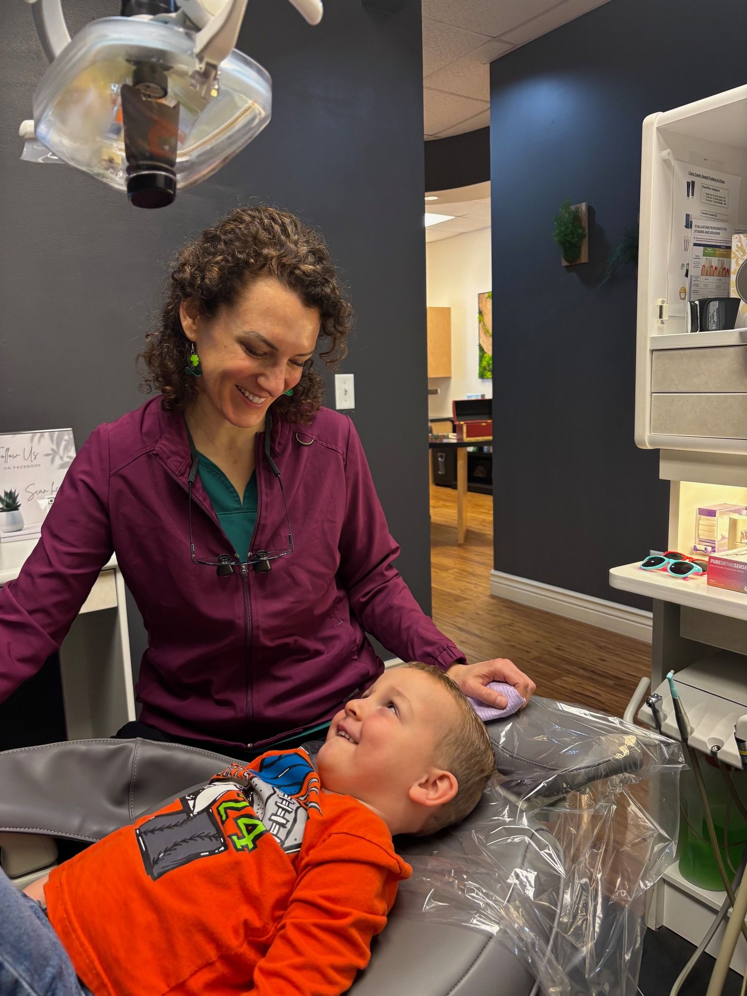 A group of women are posing for a picture in a hallway.