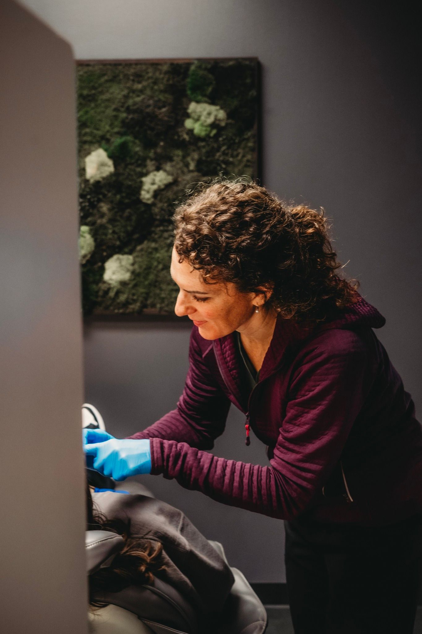 A group of women are posing for a picture in front of a christmas tree.