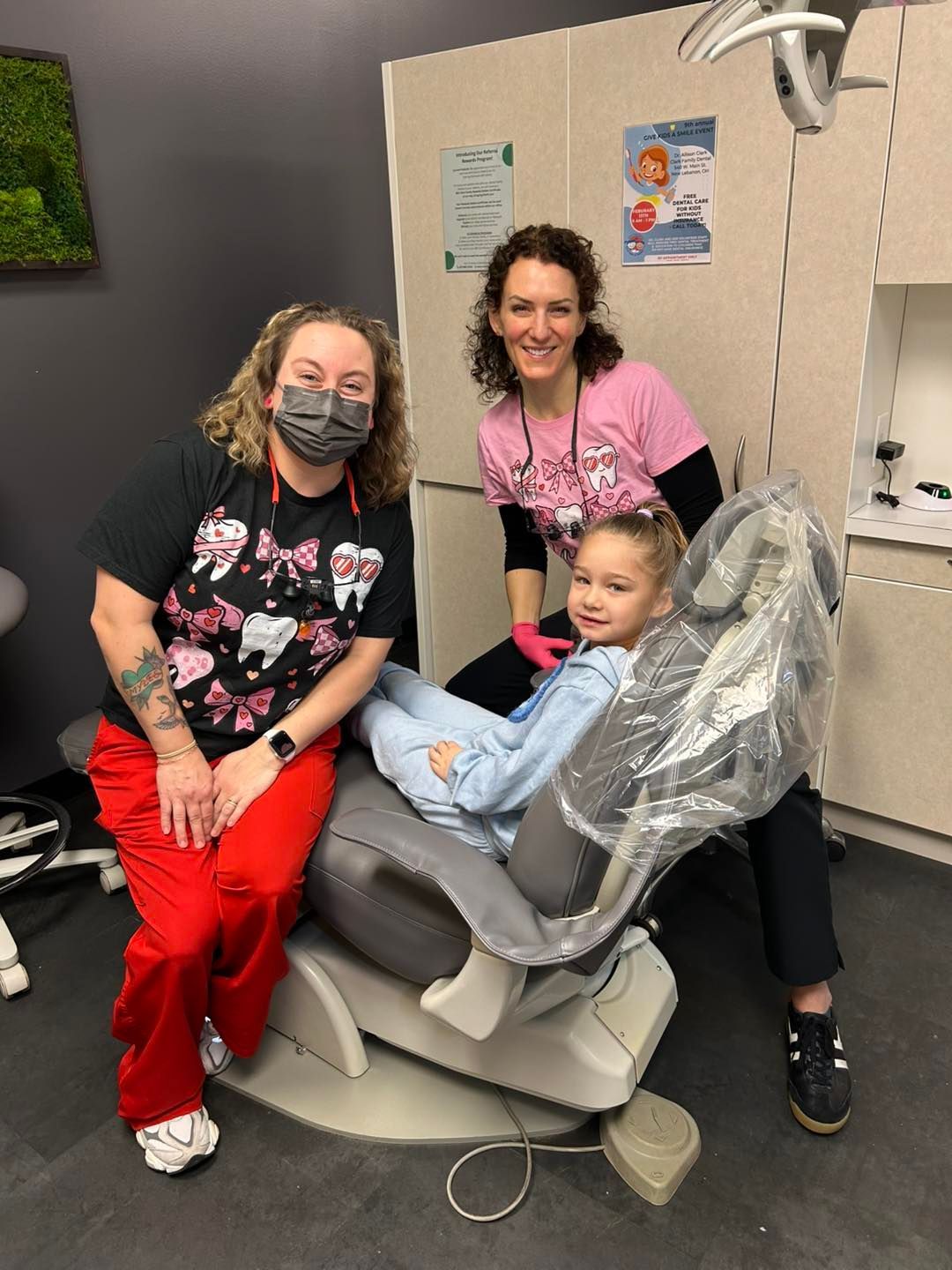 A group of women are sitting on a couch holding baskets.