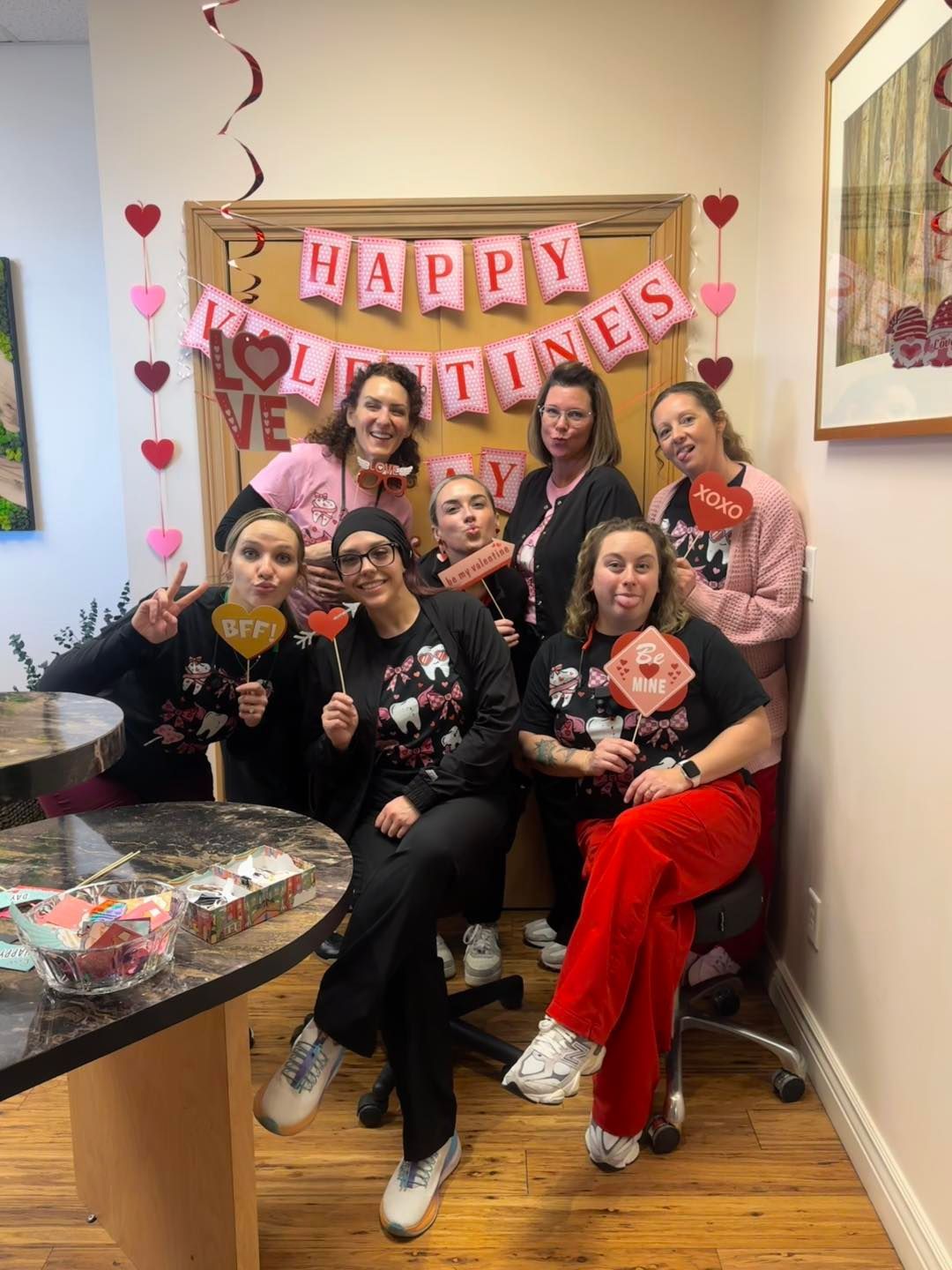 A living room with two couches and three mirrors on the wall.