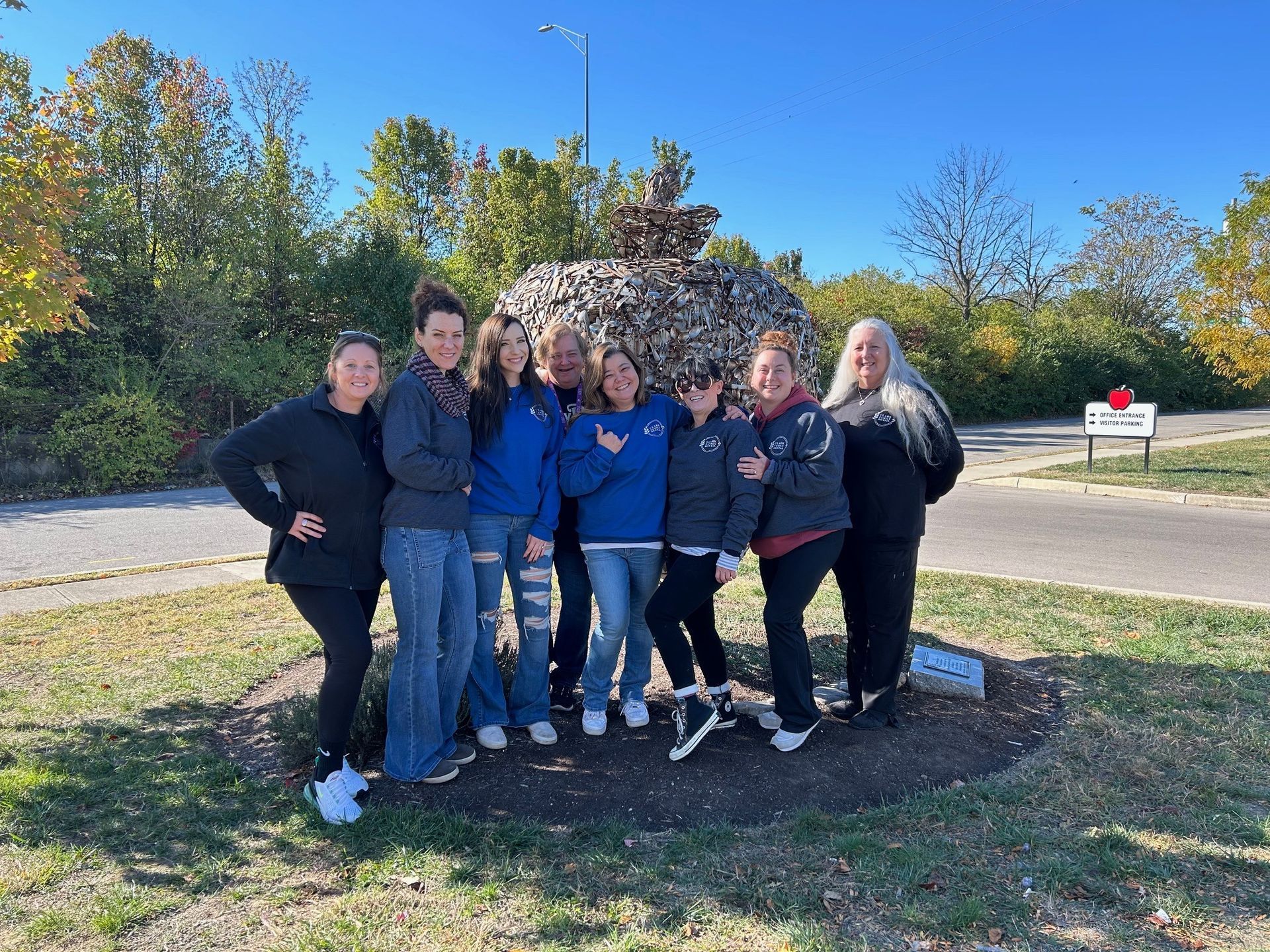 A group of women are sitting on a couch holding baskets.