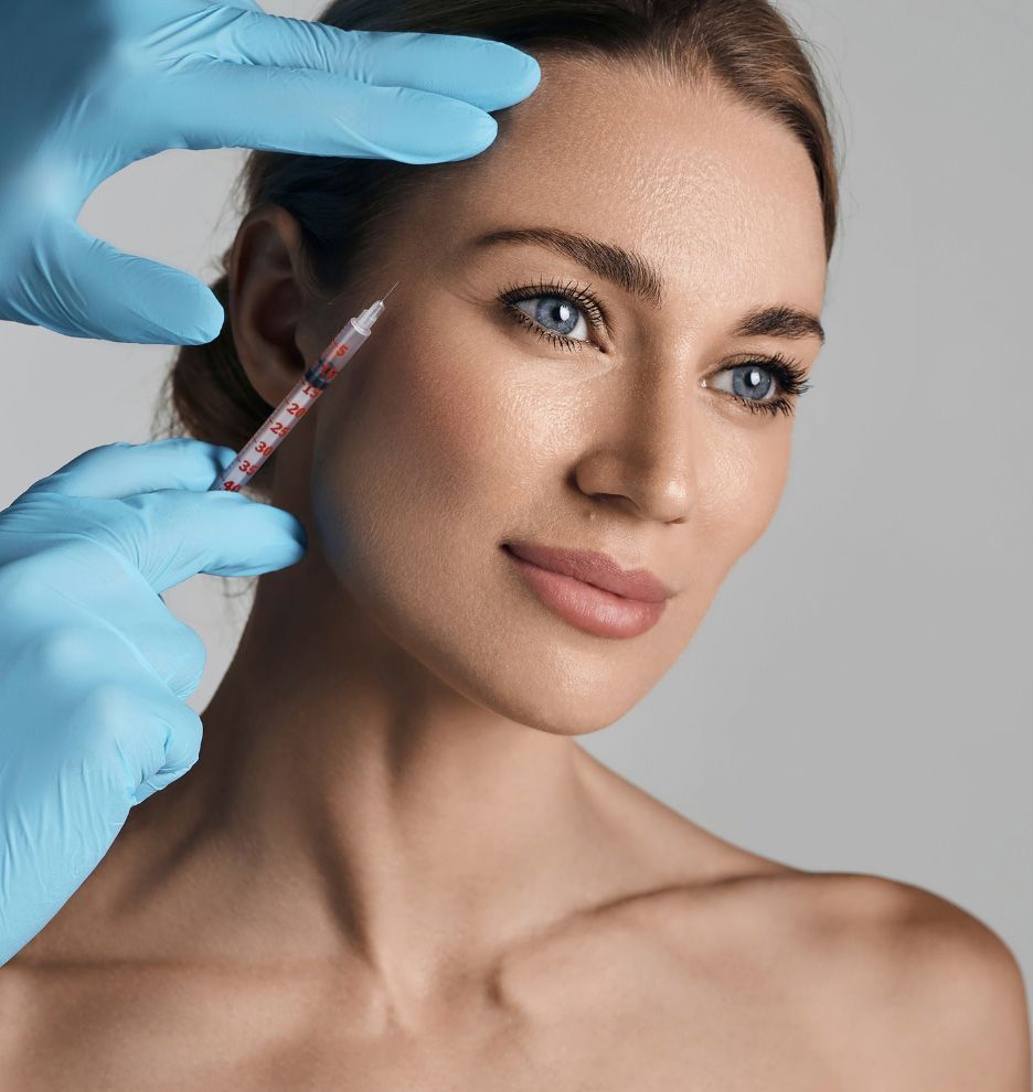 A woman is getting a botox injection in her face.