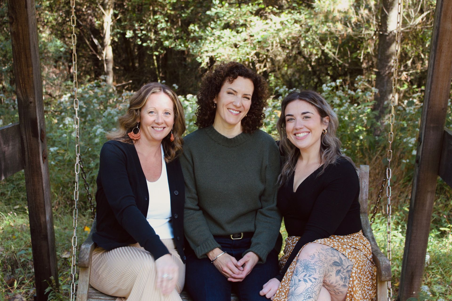 A group of women are posing for a picture in a hallway.