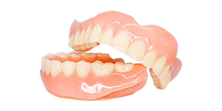A close up of a pair of dentures on a white background.