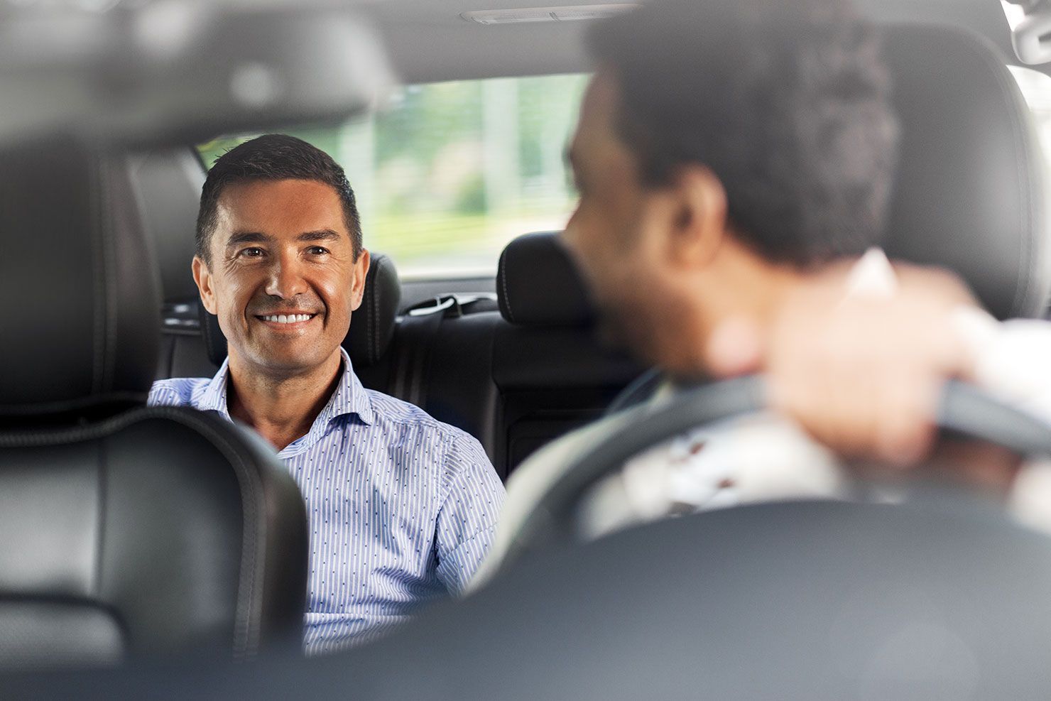 A Man is Sitting in the Back Seat of a Car — Territory Limousine Service in Litchfield, NT