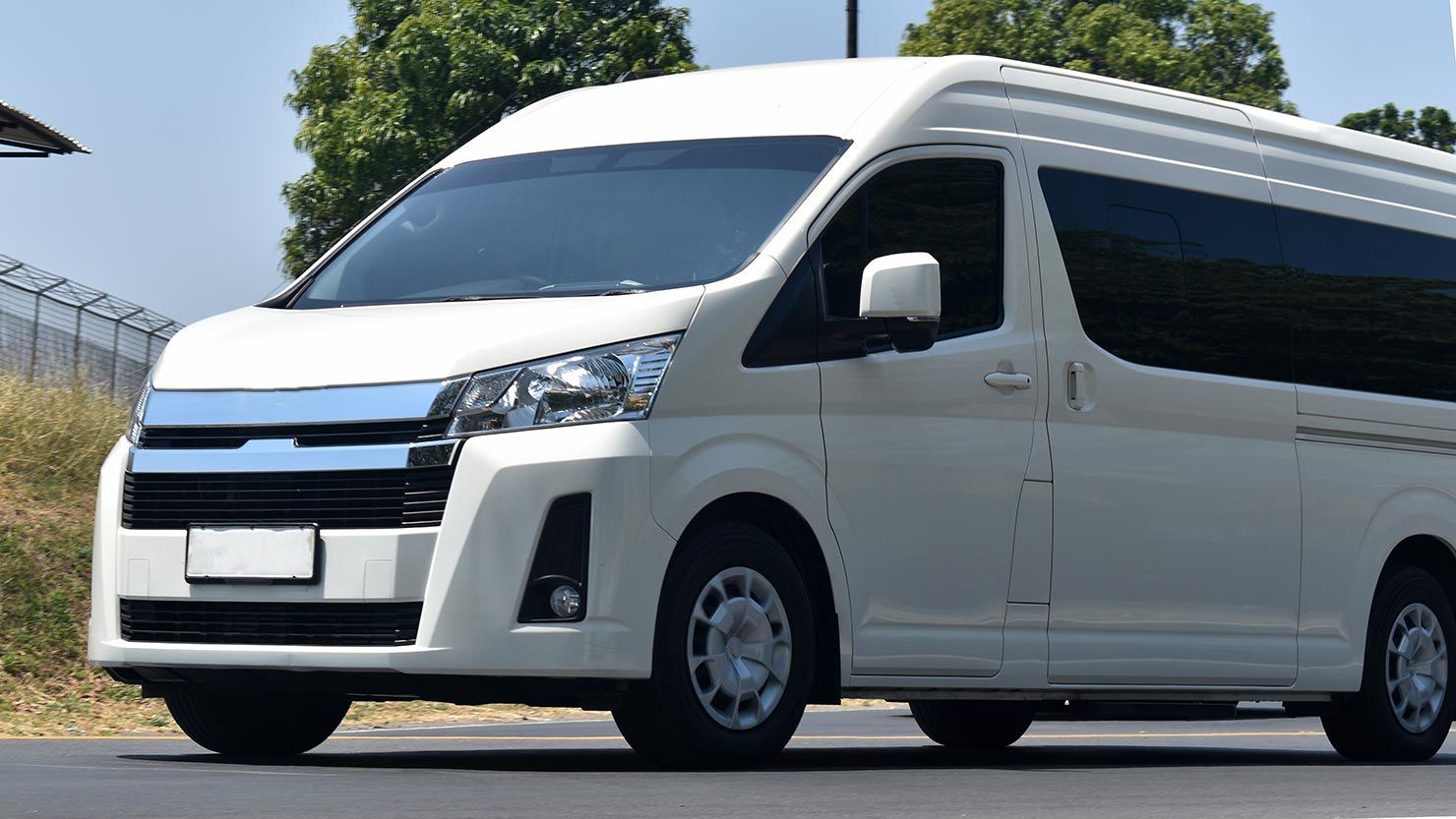 A White Van is Parked on the Side of the Road — Territory Limousine Service in Litchfield, NT