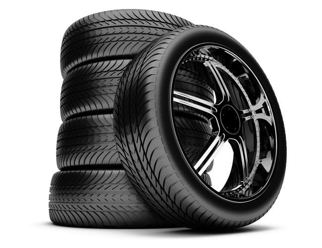 Four tires are stacked on top of each other on a white background