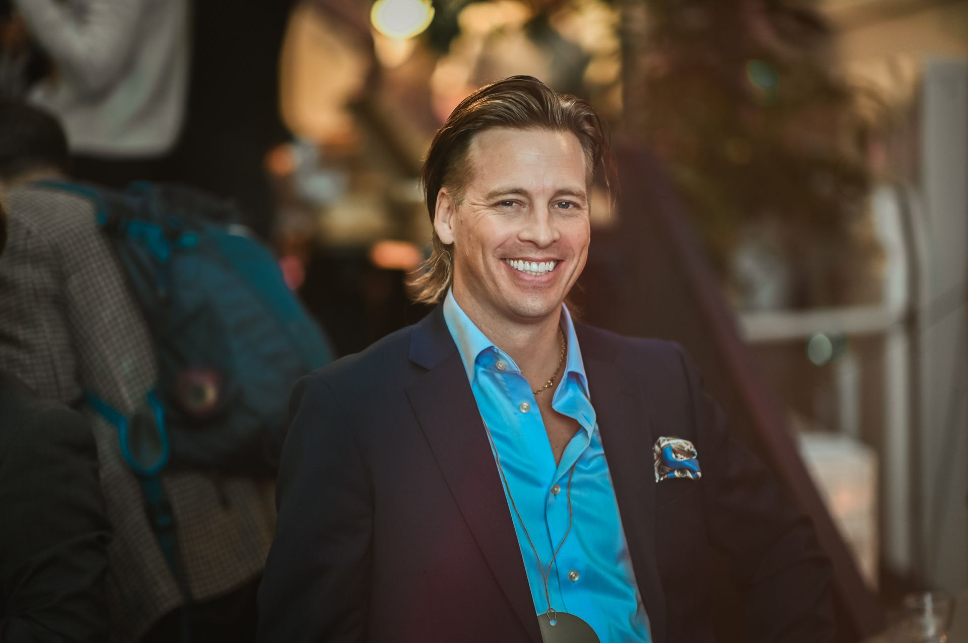 People seated around a large table in a meeting room, engaged in discussion.