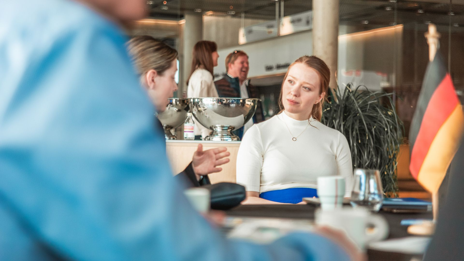 Street in Stavanger, Norway, lined with colorful buildings. Church spire visible, under an orange sunset.