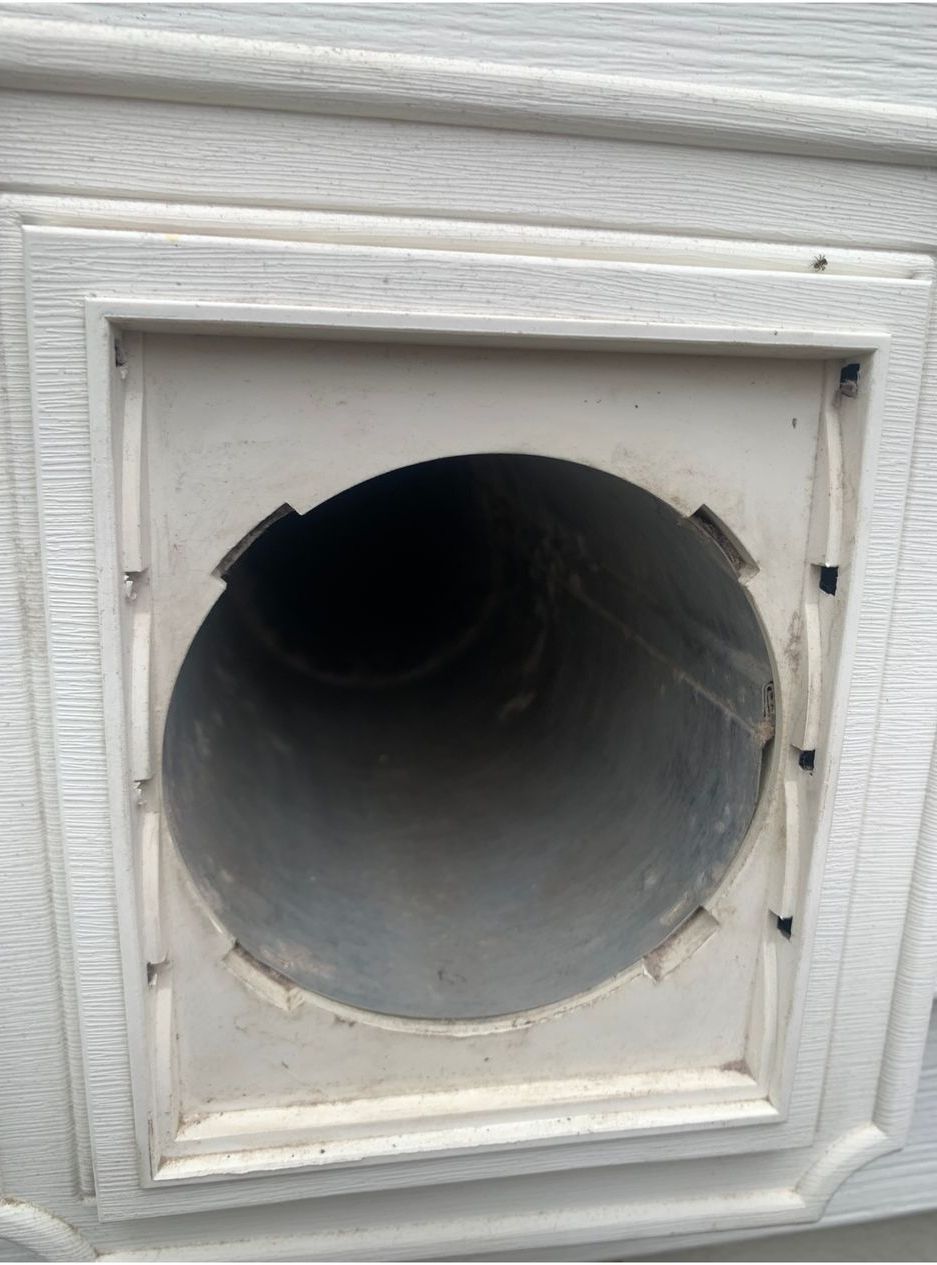 A white door with a hole in the middle of it.