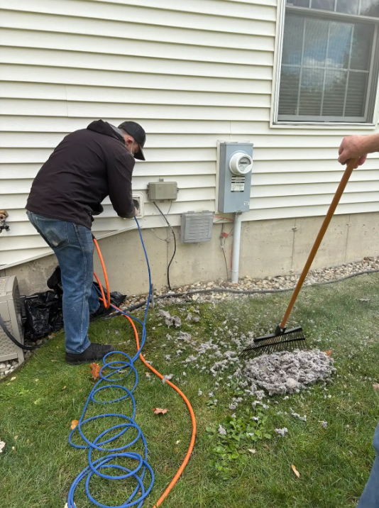 A close up of a dirty duct on a blue background.