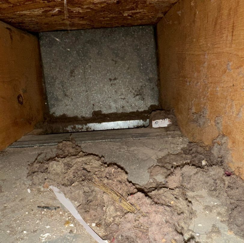 A dirty room with a lot of dust on the floor.