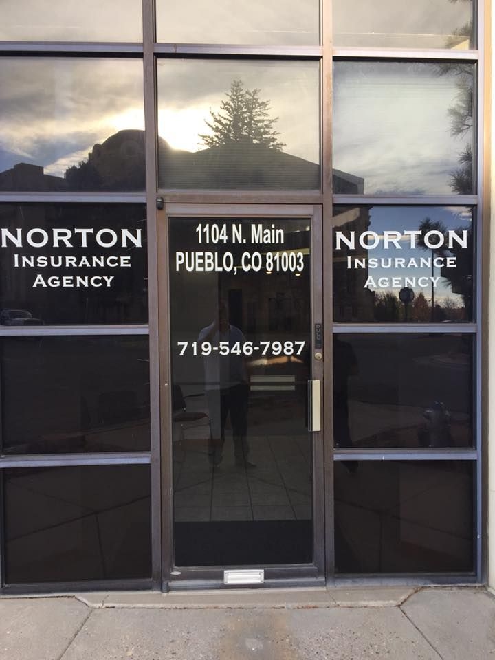 Norton Insurance Agency storefront, 1104 N. Main, Pueblo, CO. Phone number: 719-546-7987. Glass door with logo.