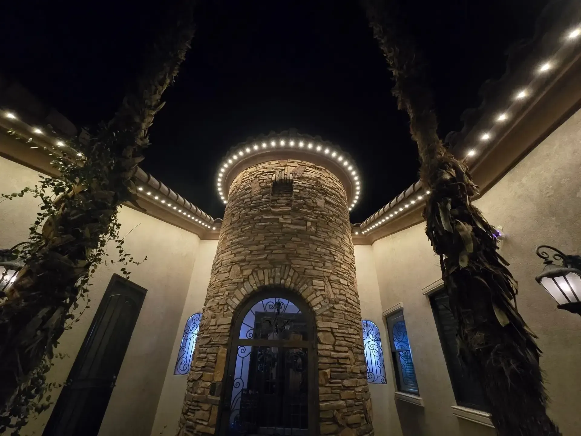 Stone tower entryway with warm outdoor lighting at night