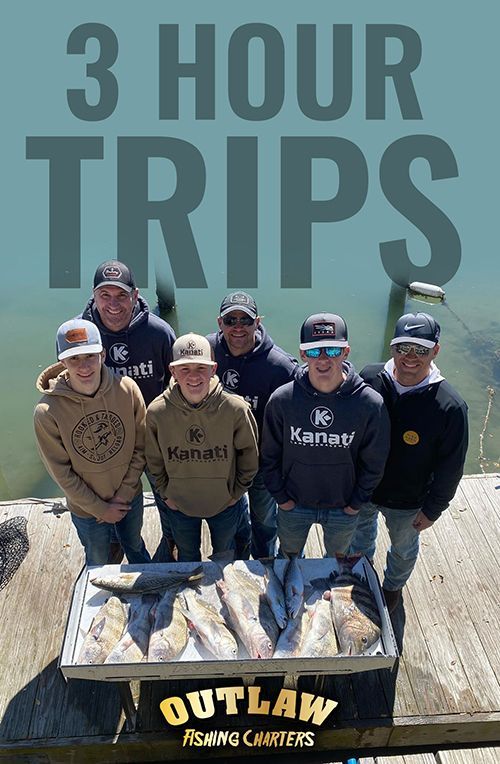 A group of men are standing next to a table with fish on it.