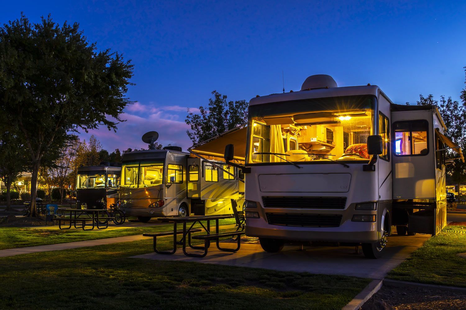 RV is Parked in a Campground at Night