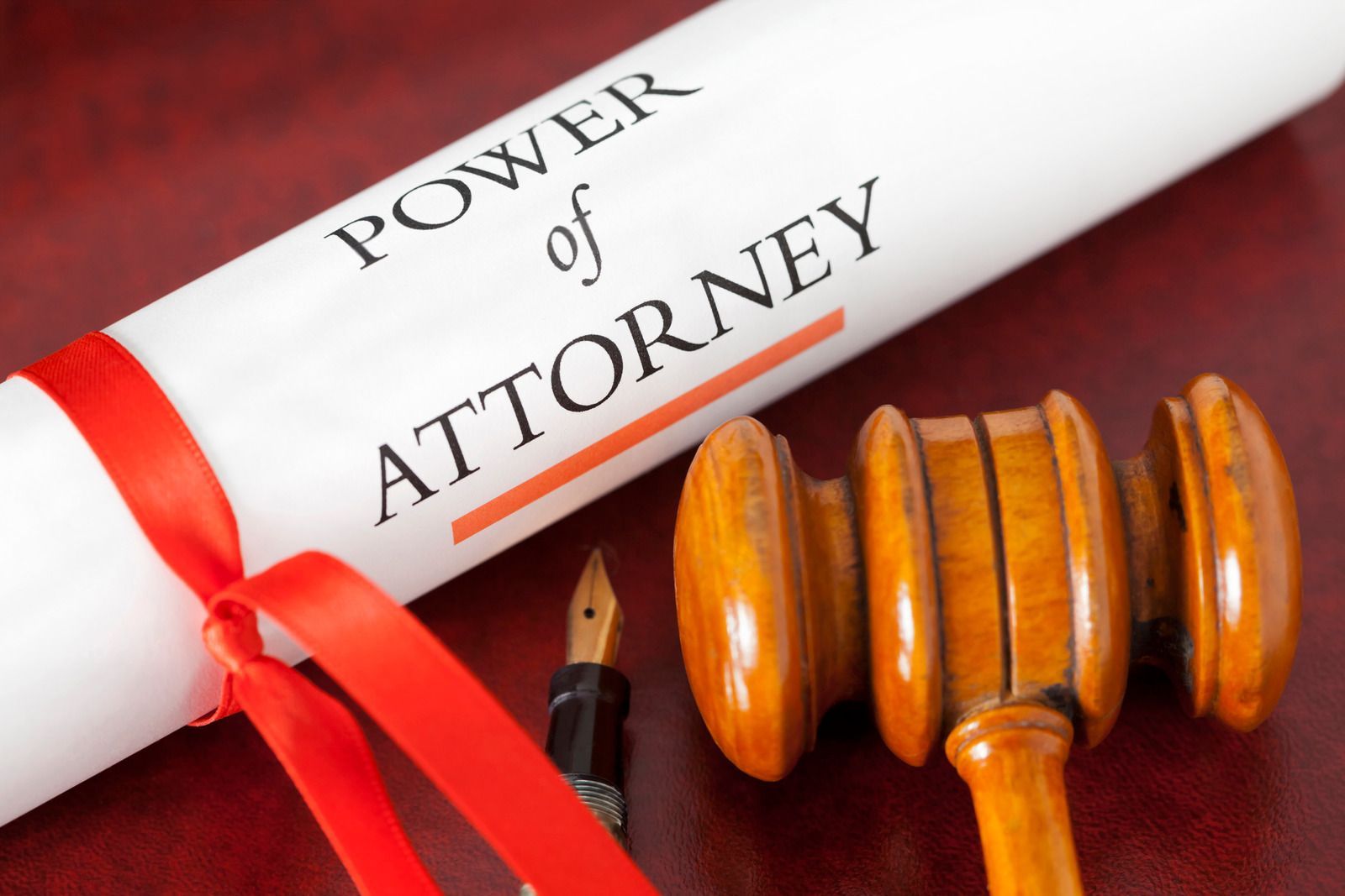 A power of attorney is tied with a red ribbon