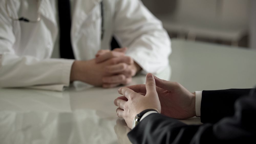 A Man Table, Hands Clasped — Tenth Avenue Accountants & Financial Advisors in Toukley, NSW