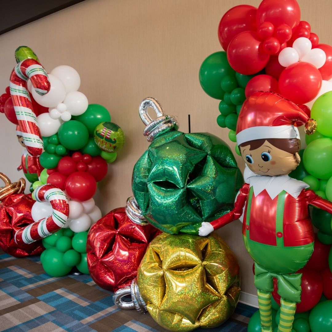 Christmas themed backdrop decorations with a life size christmas elf