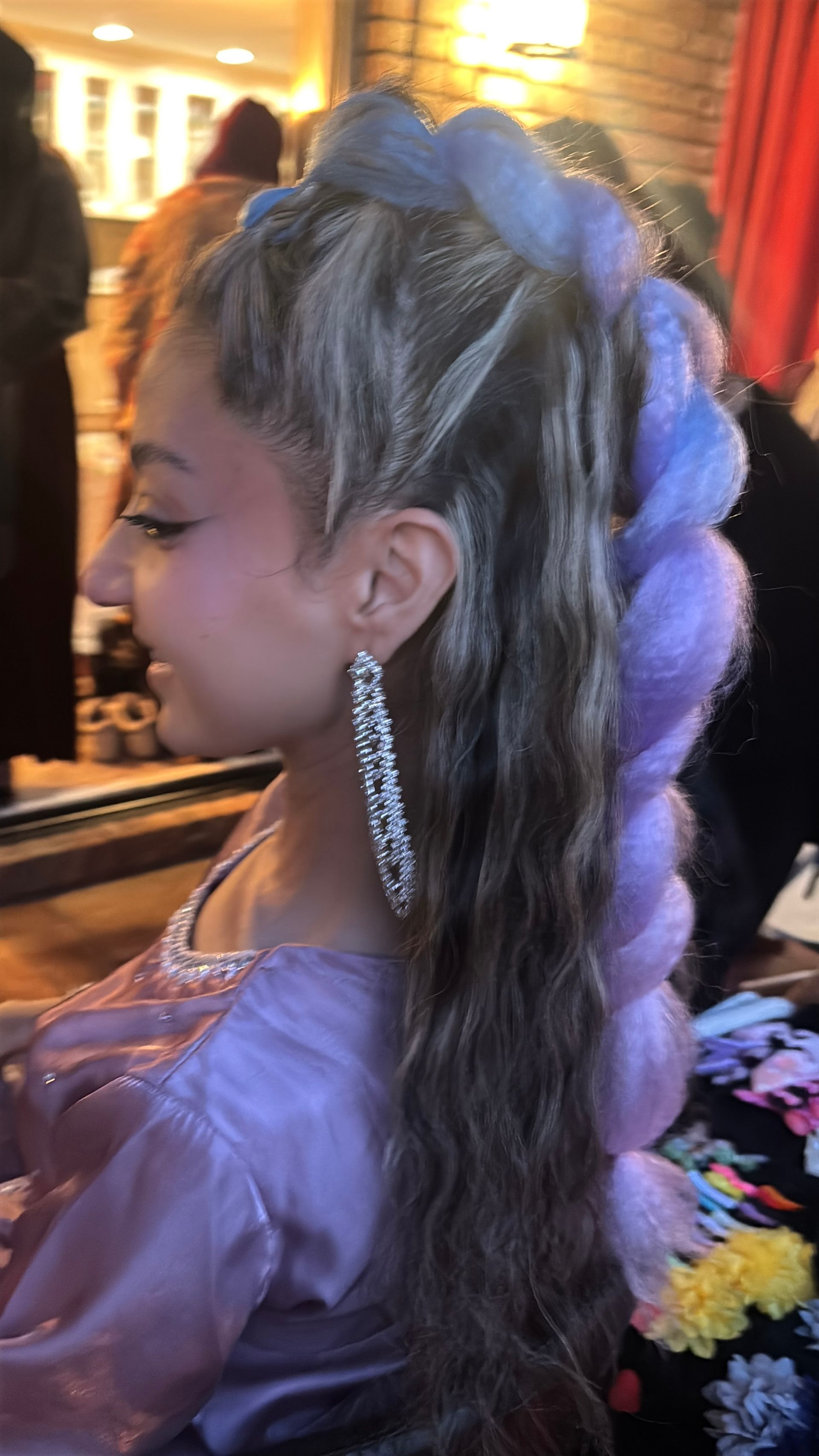 Woman Wearing purple with purple Rumi Braid