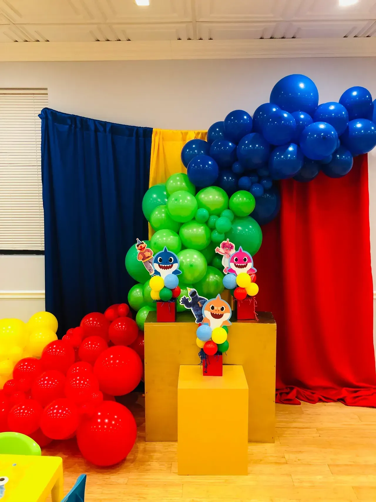 A room filled with balloons and decorations for a baby shark birthday party.