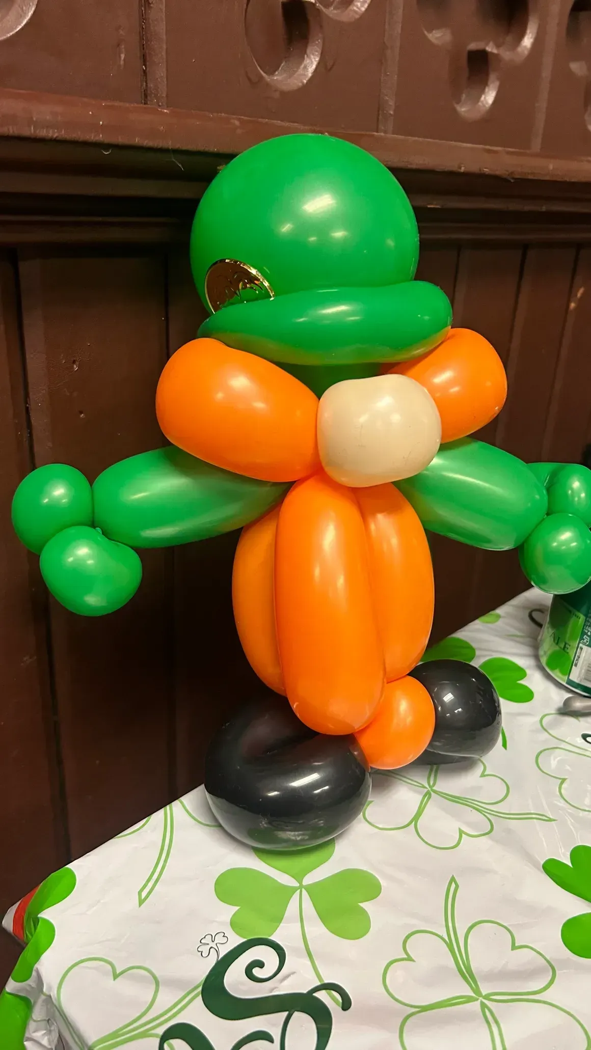 Leprechaun made of green, orange, and white balloons; St. Patrick's Day themed.