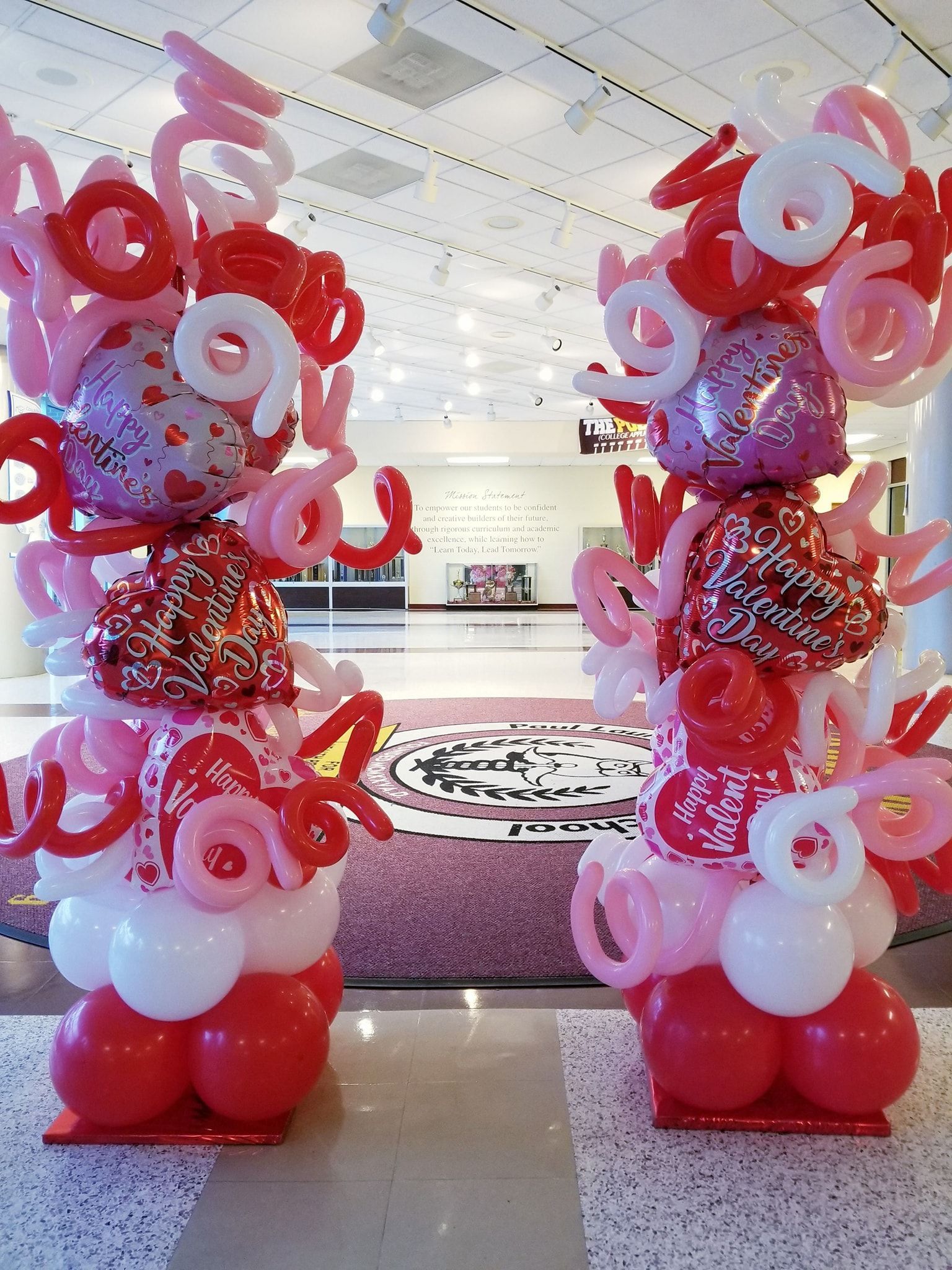 A bunch of red and pink balloons stacked on top of each other