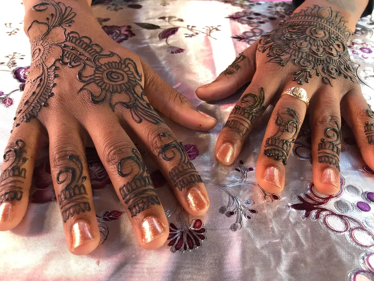A close up of a person 's hands with henna on them