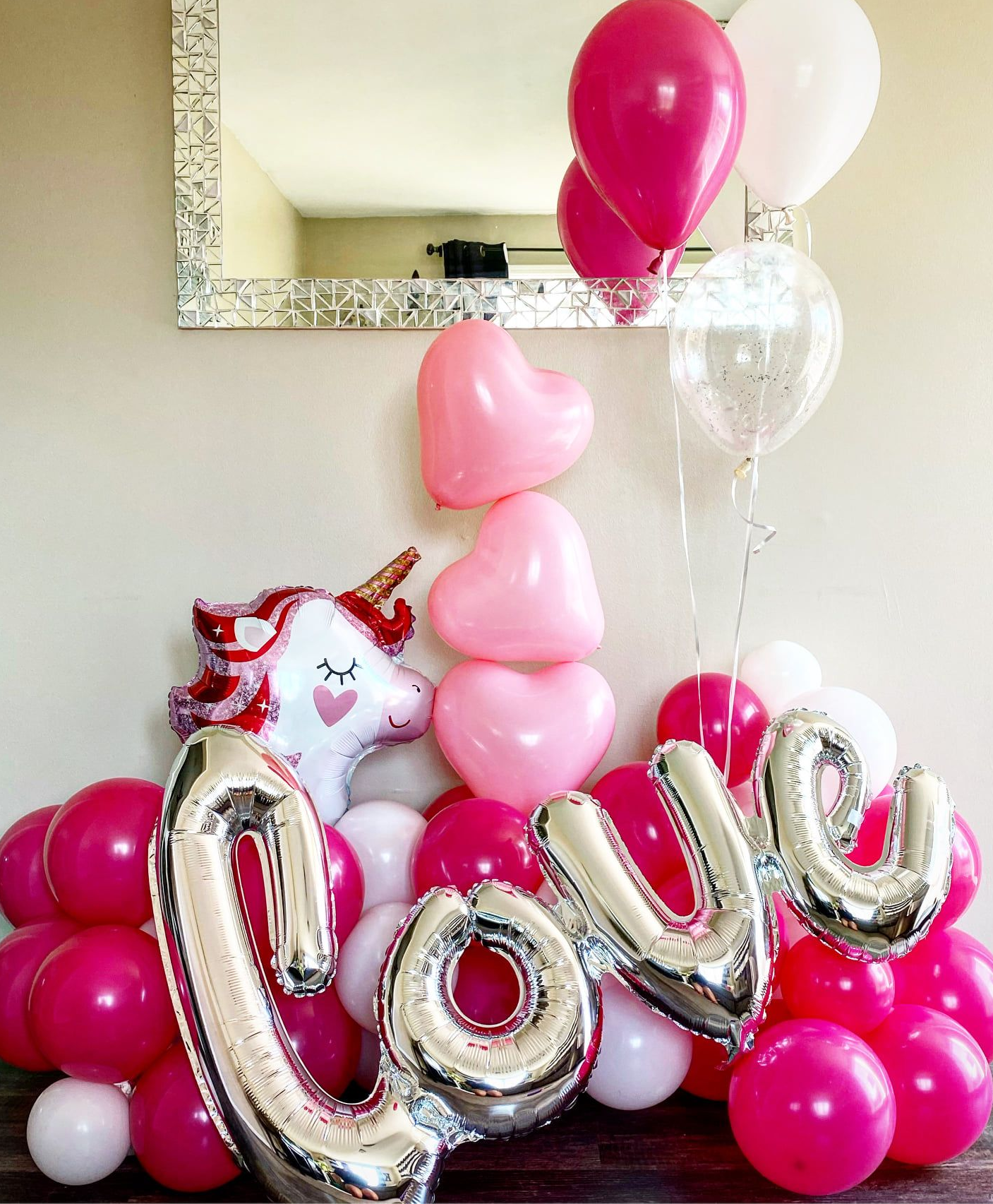 Pink and silver balloon display with 