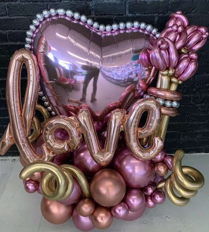 Pink and gold balloon arrangement spelling 