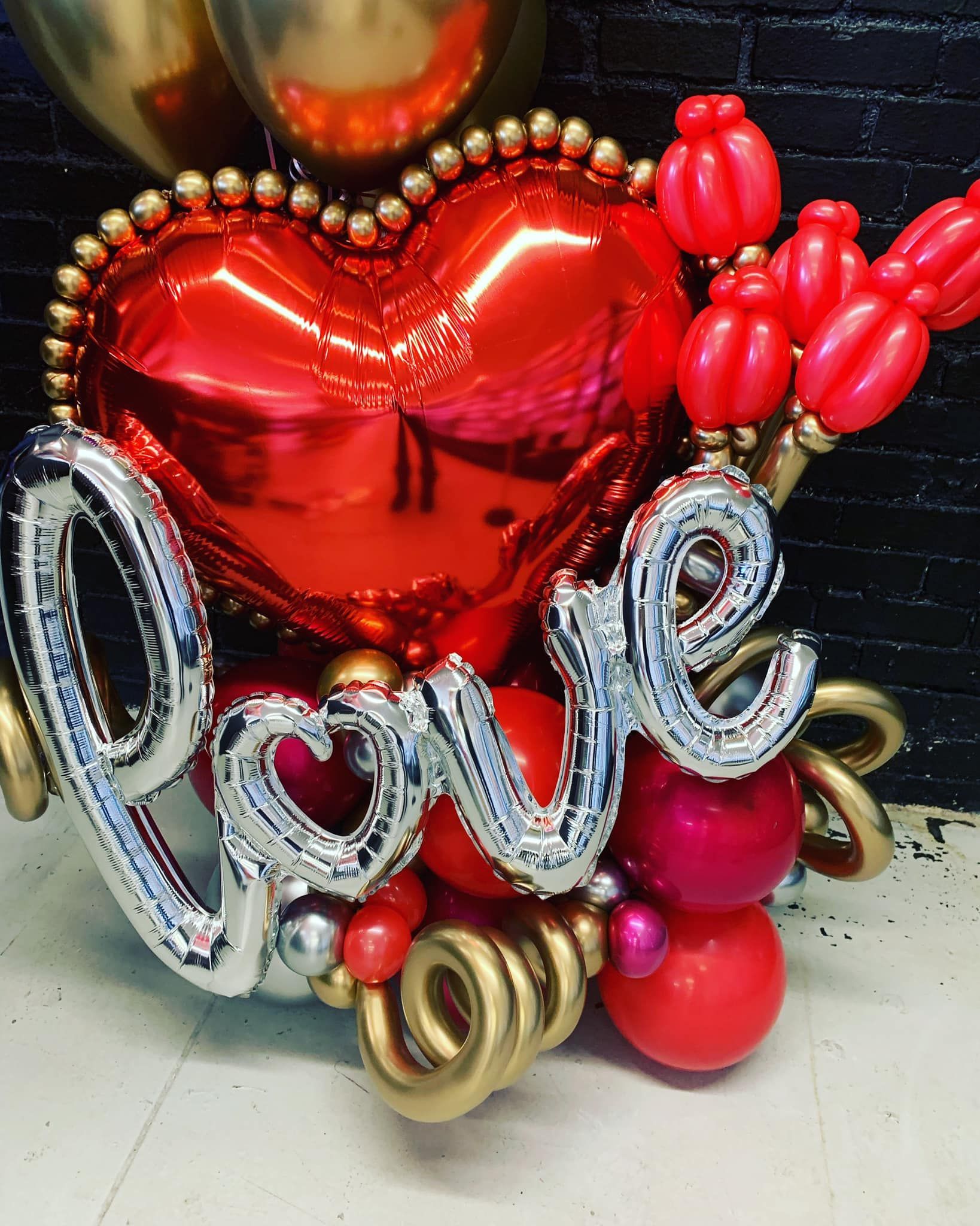 A heart shaped balloon with the word love on it