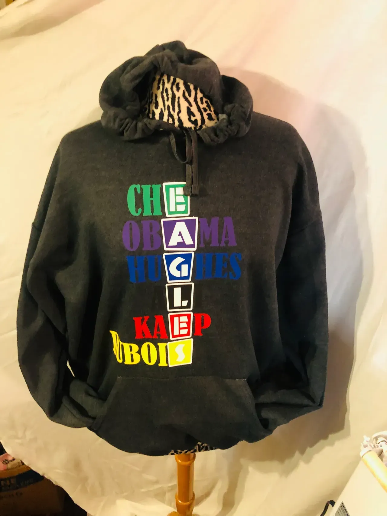 Gray hoodie with colorful stacked letters spelling