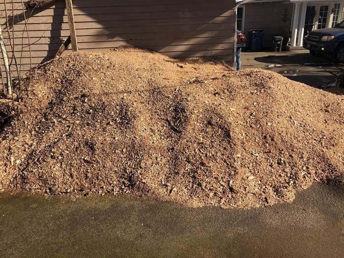 A pile of dirt is sitting in front of a house.