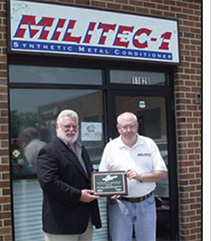 Two men standing in front of the Militec office.