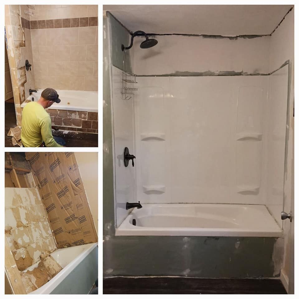 Bathroom renovation: Person installing new shower unit. Old tile/wall removed; new white surround in place.