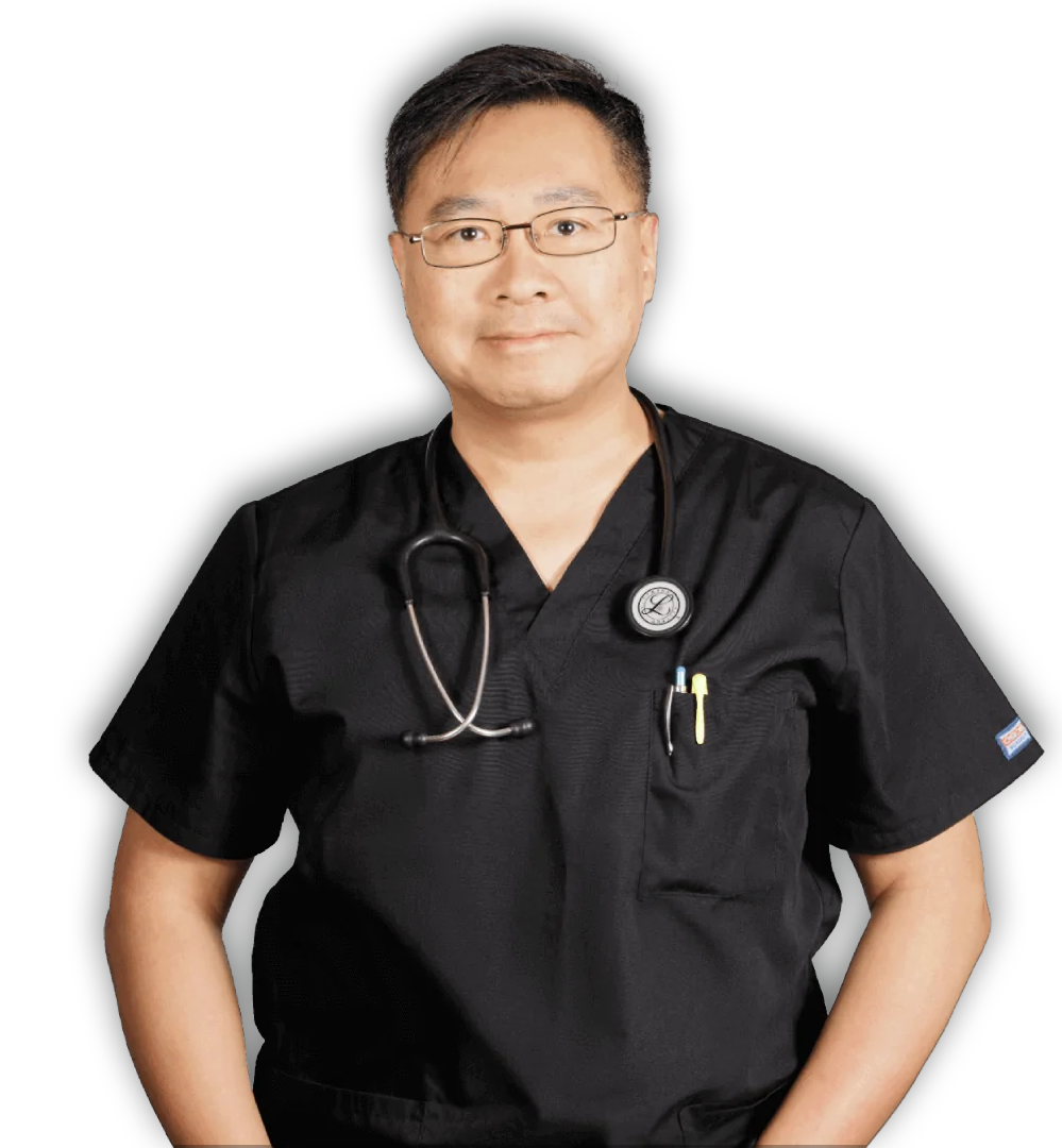 A man wearing a black scrub top with a stethoscope around his neck
