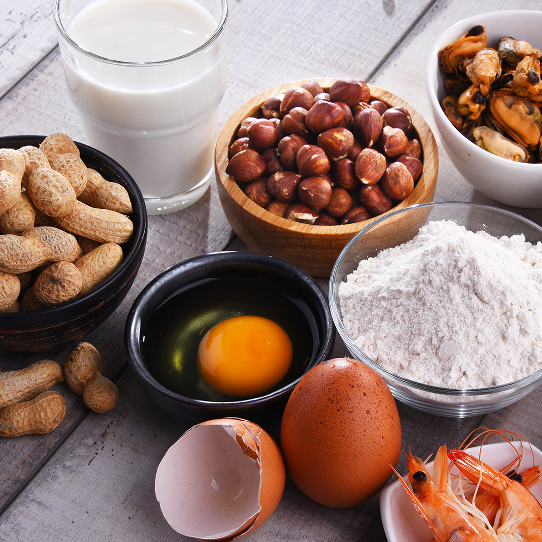 A table topped with bowls of food including eggs and peanuts