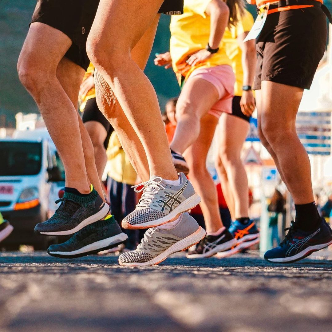 A group of people are running on a street.
