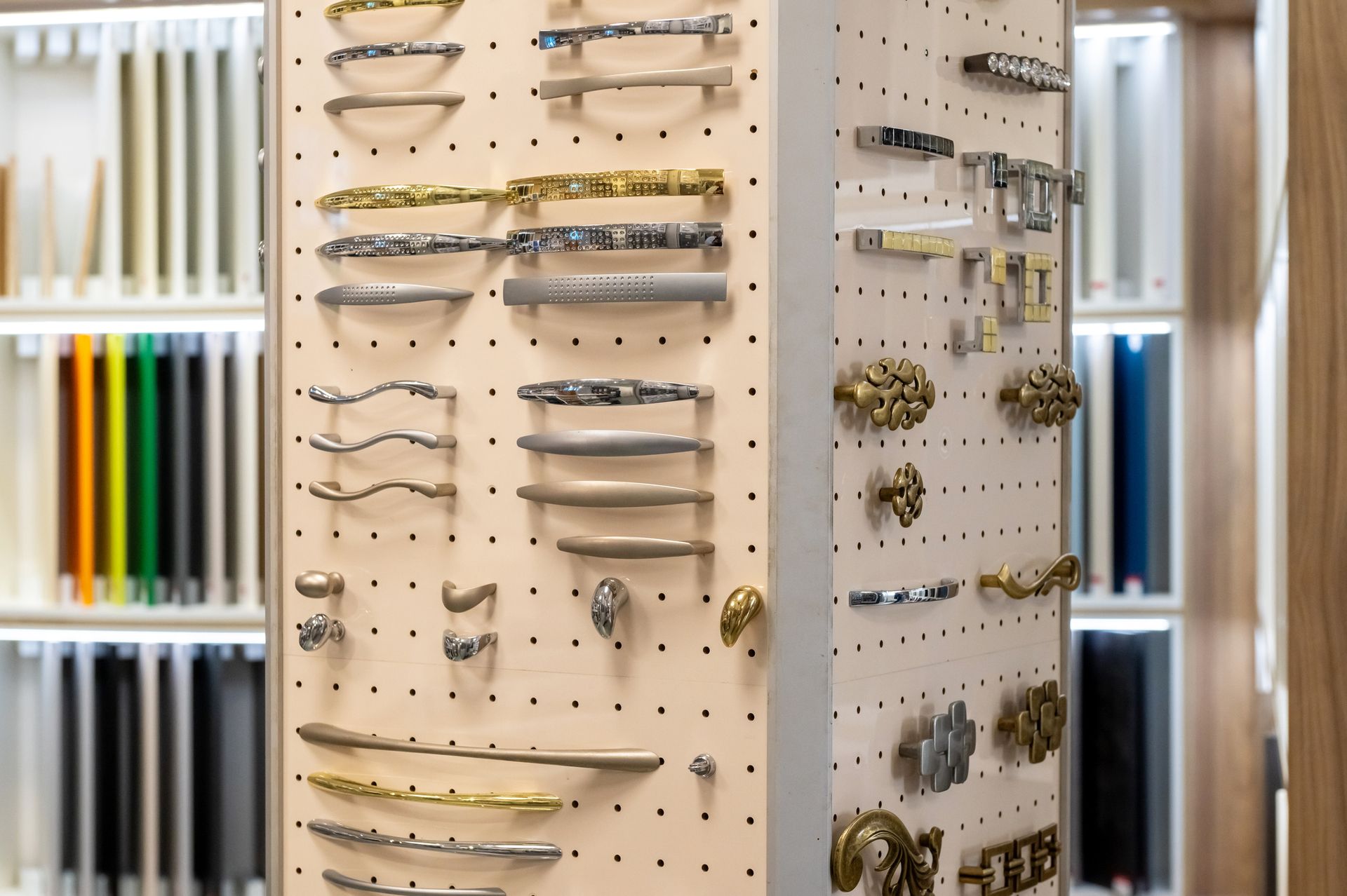 Display of cabinet hardware and samples in a showroom setting.